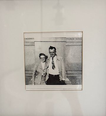 Vintage black and white photo of a man and woman posing together outside a building, circa 1950s.