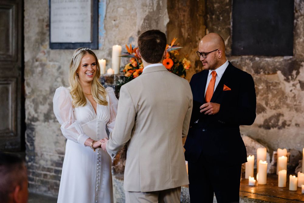 bride groom and celebrant at the asylum chapel in London at a wedding