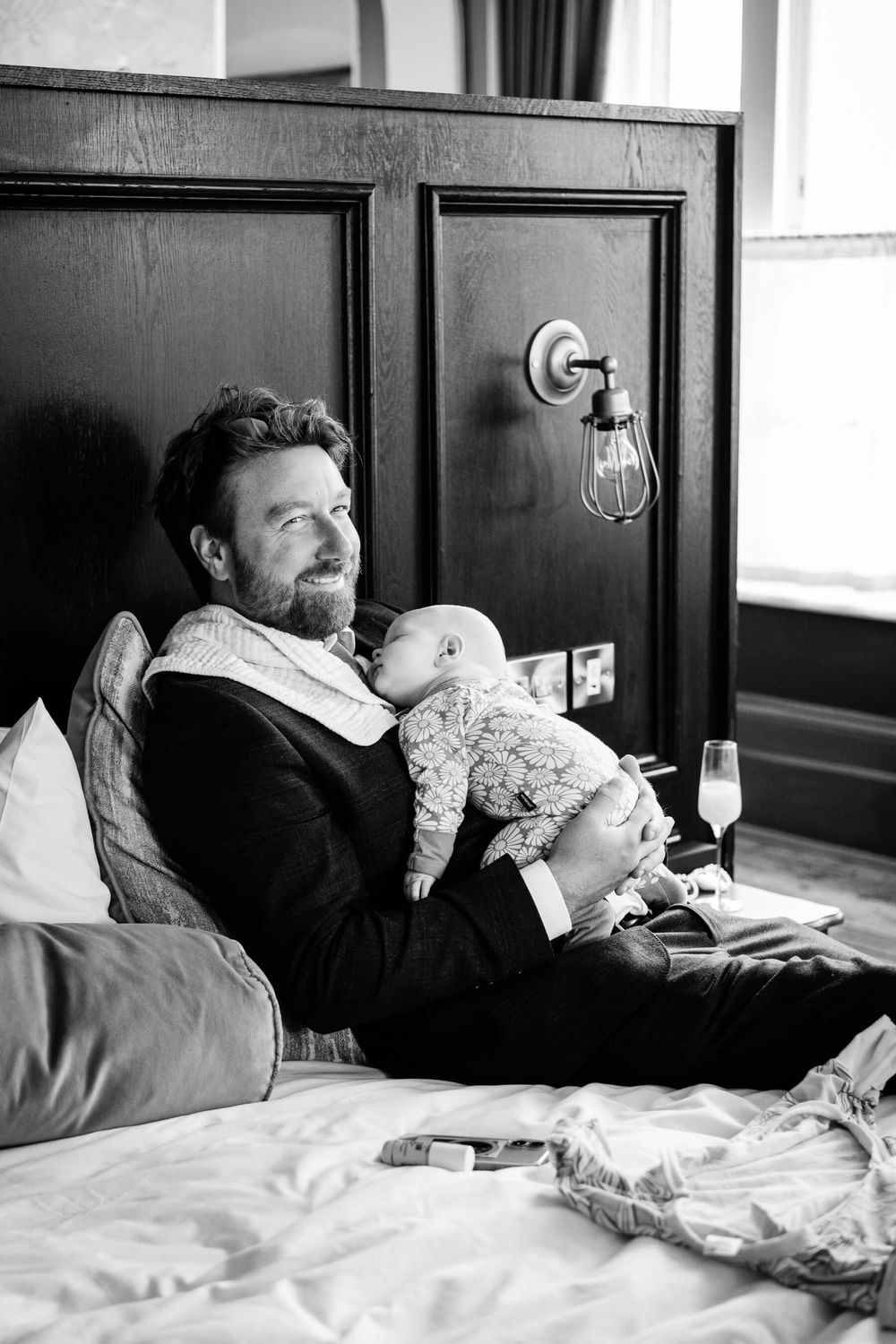 man holding baby at wedding in London.