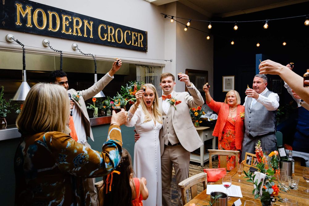 bride and groom doing shots at wedding in London