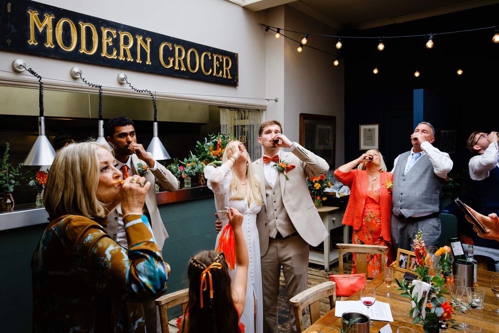 bride and groom doing shots during speeches at wedding