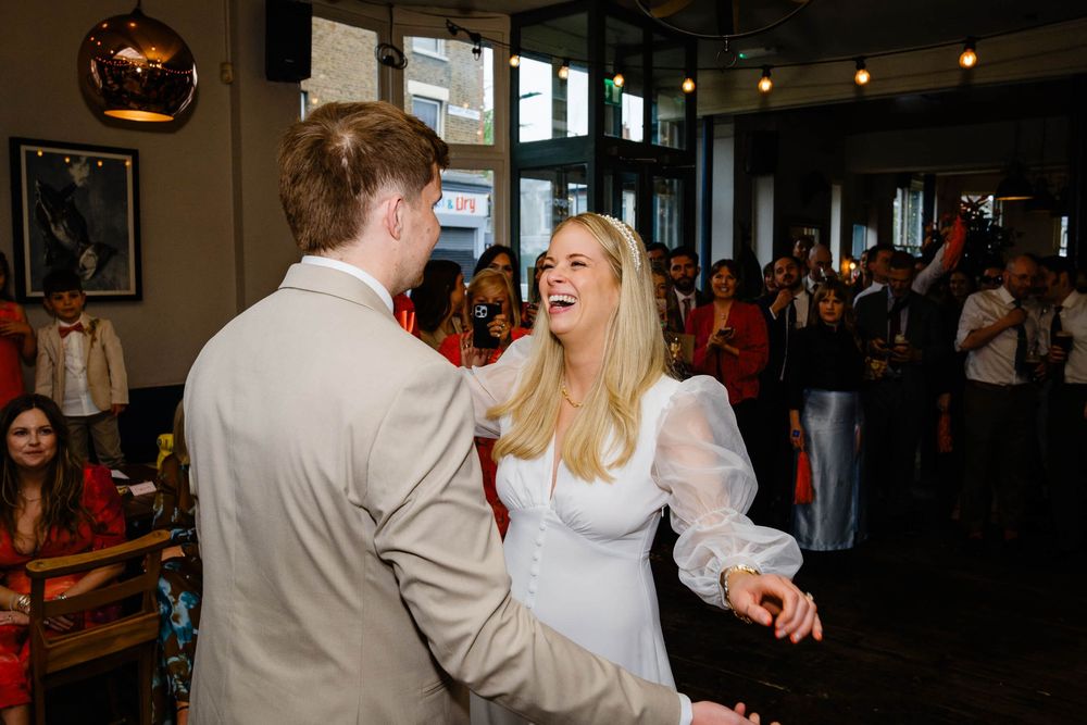 bride and groom  smiling and dancing together