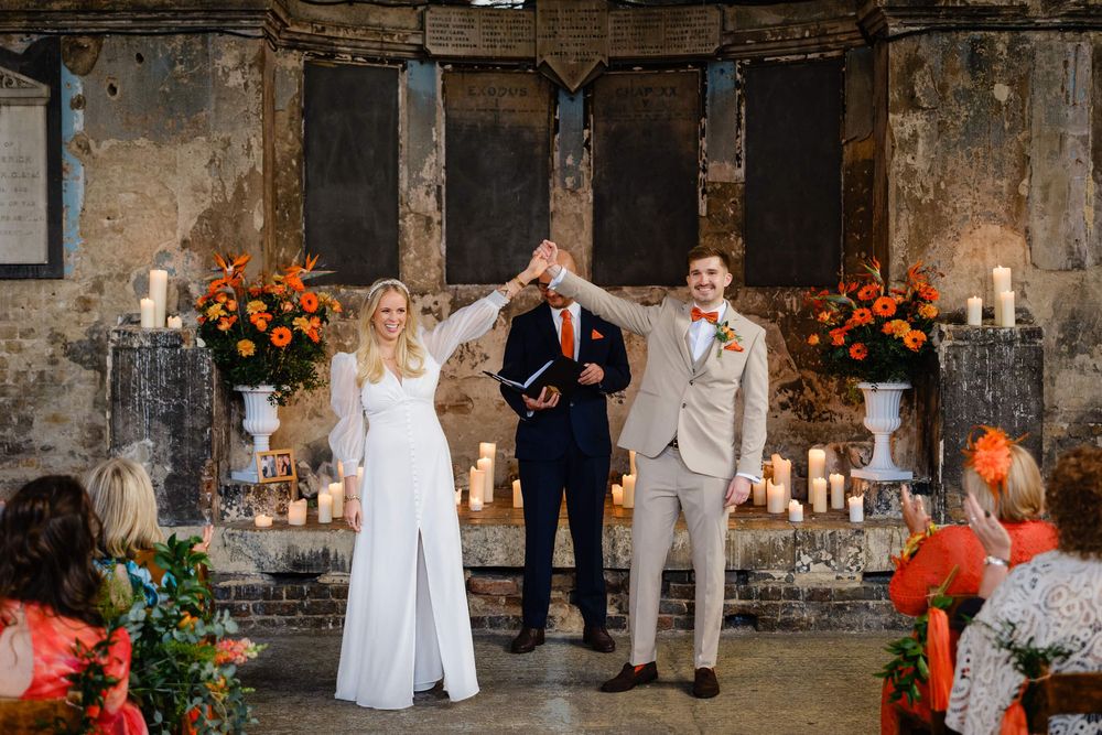 bride and groom cheering after getting married at asylum chapel in London