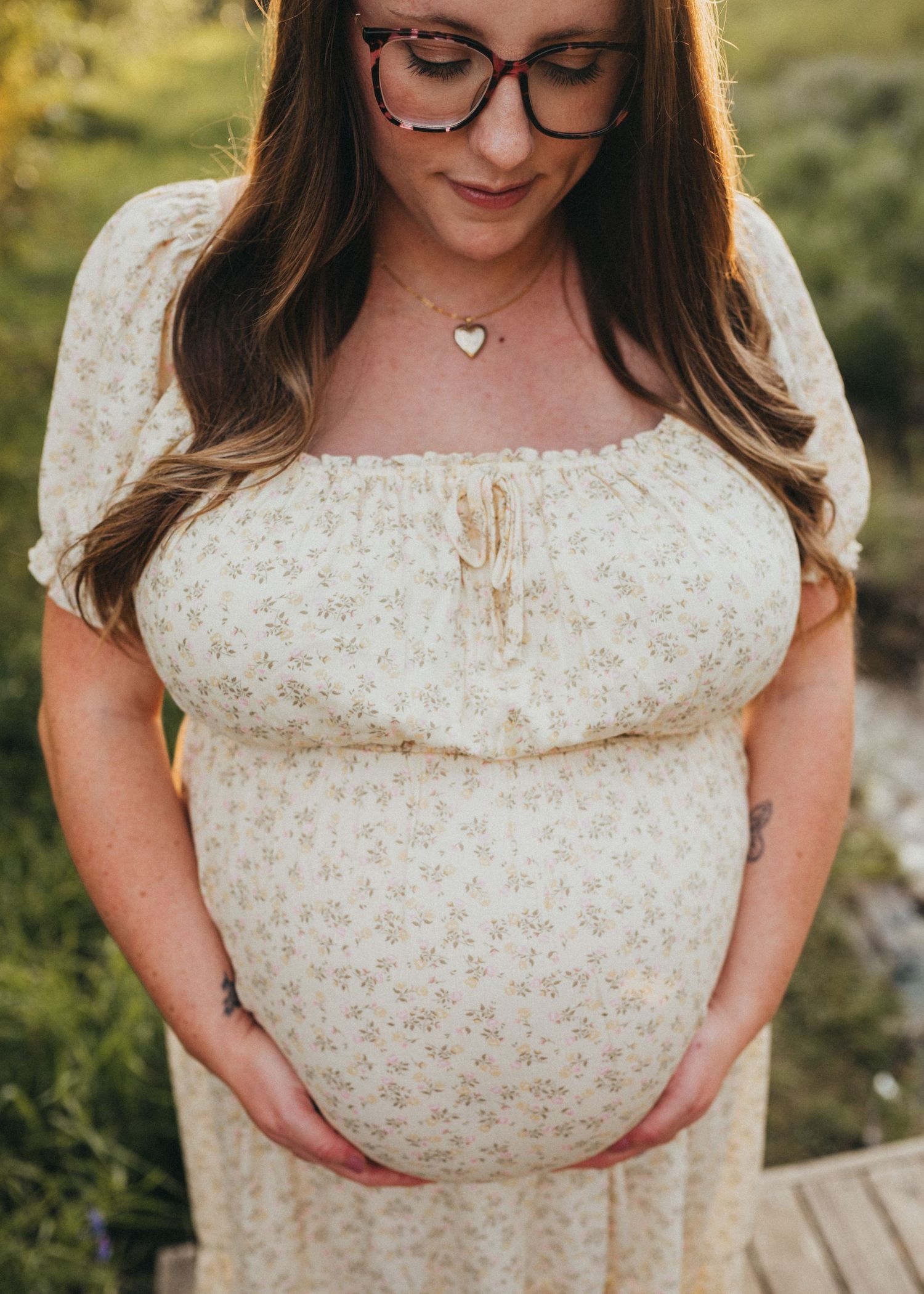 Close-up portrait of a pregnant woman holding her belly during a maternity session