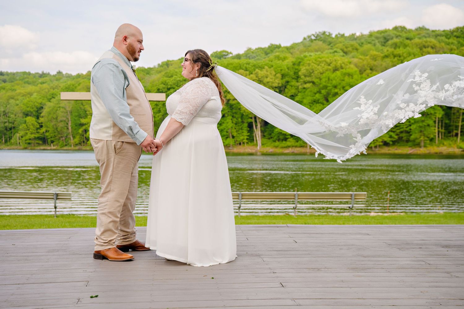 Bride and Groom posing near the water at Camp NEOSA after their wedding ceremony in Carrollton, Ohio in May.