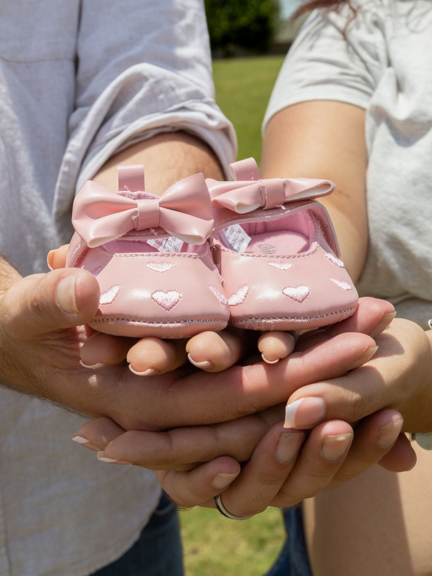 couple holding baby shoes in Austin,Tx