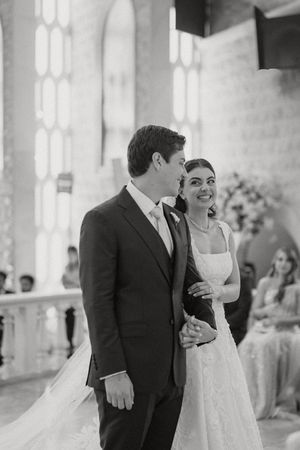 A series of black and white wedding reception photos showing joyful moments between a couple in formal attire.
