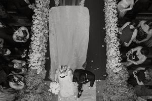 A black and white collage of wedding celebration moments showing dancing, cake cutting, and floral decorations.