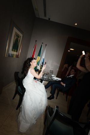 A series of dark indoor shots showing a bride in a white wedding gown moving through a dimly lit room.