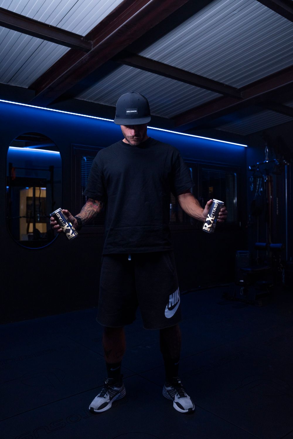Atmospheric shot of a person in a dark gym setting; moody fitness lifestyle and brand storytelling.