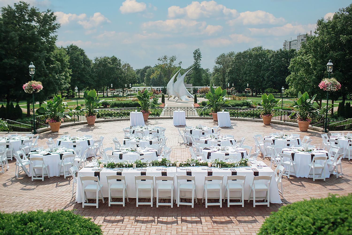 Franklin Park Conservatory & Botanical Gardens Outdoor wedding venue setup with rows of white chairs and a grand fountain in the background.