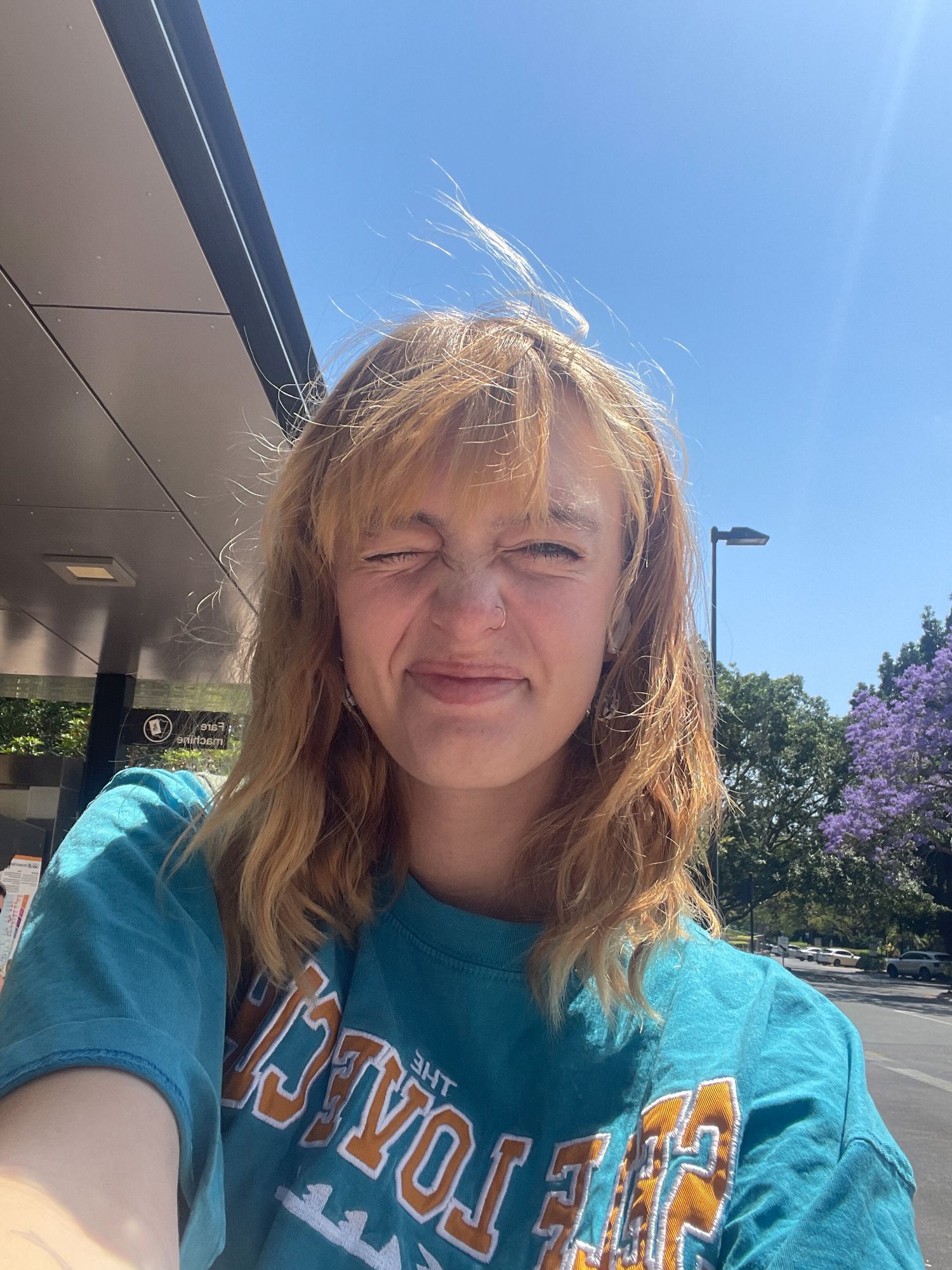 A series of selfie photos showing someone in a turquoise sweatshirt with blonde hair against a sunny outdoor background.