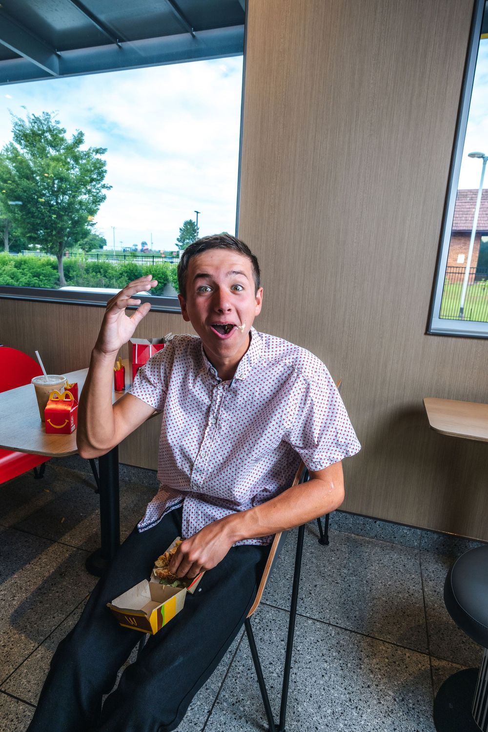 A sequence of photos showing someone making exaggerated expressions while eating at McDonald's.