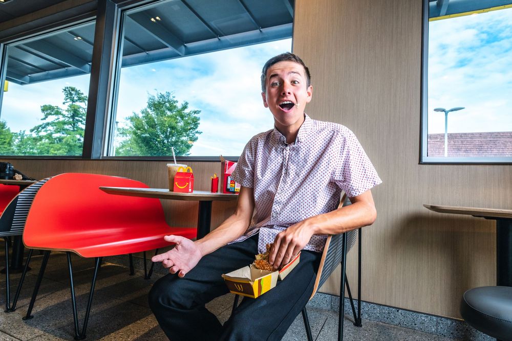 A sequence of photos showing someone sitting at a red booth in a restaurant making animated expressions and gestures.