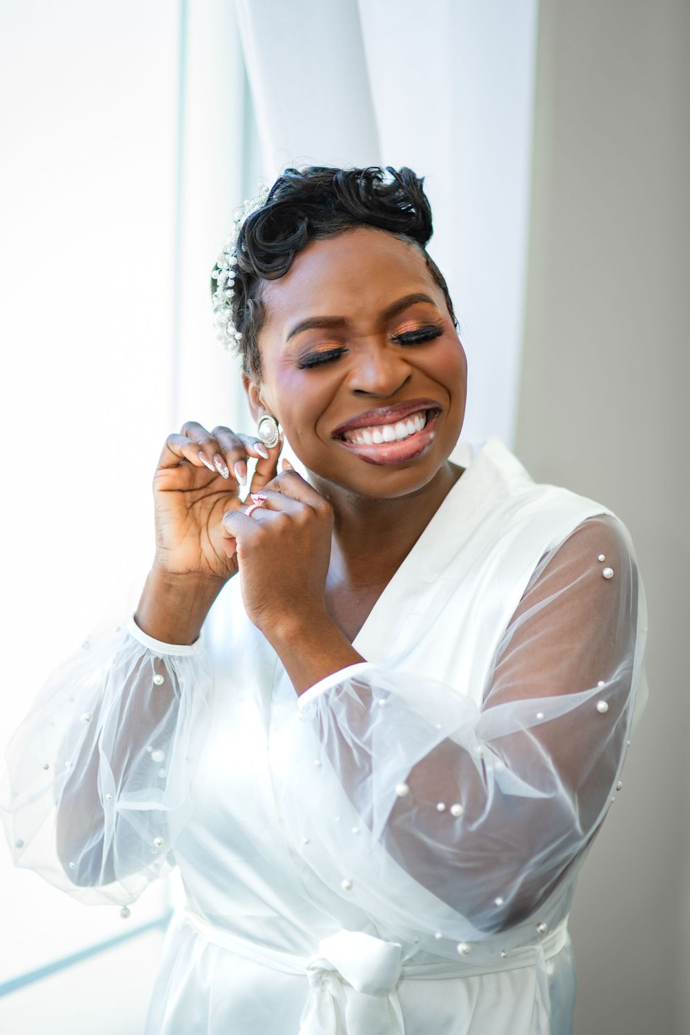 Elegant portrait series showing joyful expressions in white sheer-sleeved robe.