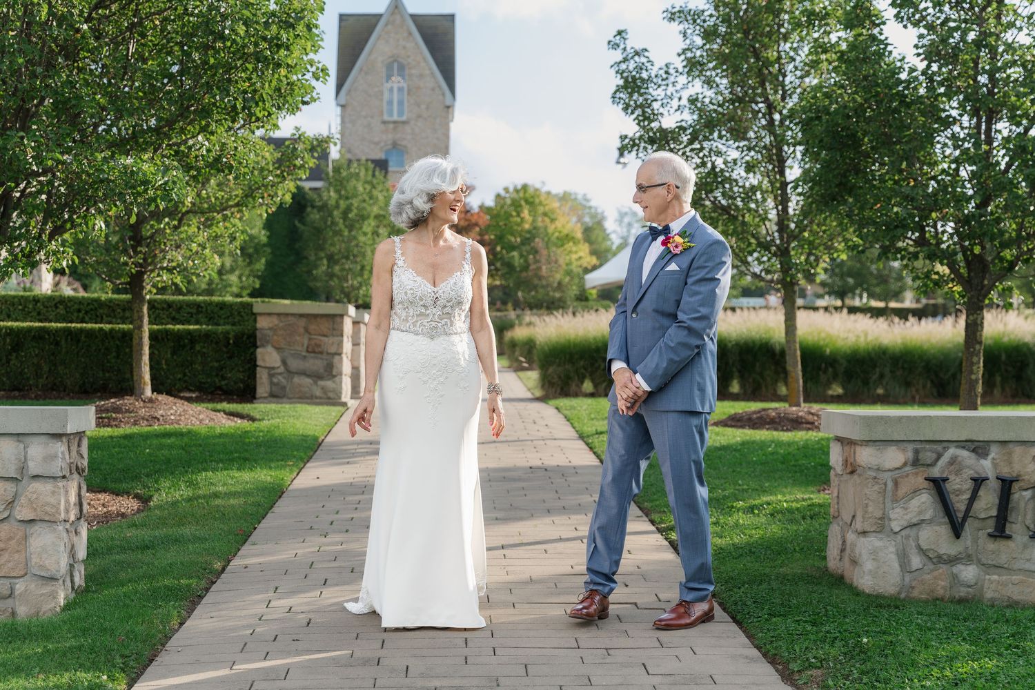 Bride and groom share a first look on the stone path near the Carriage House at Vineland Estates Winery.