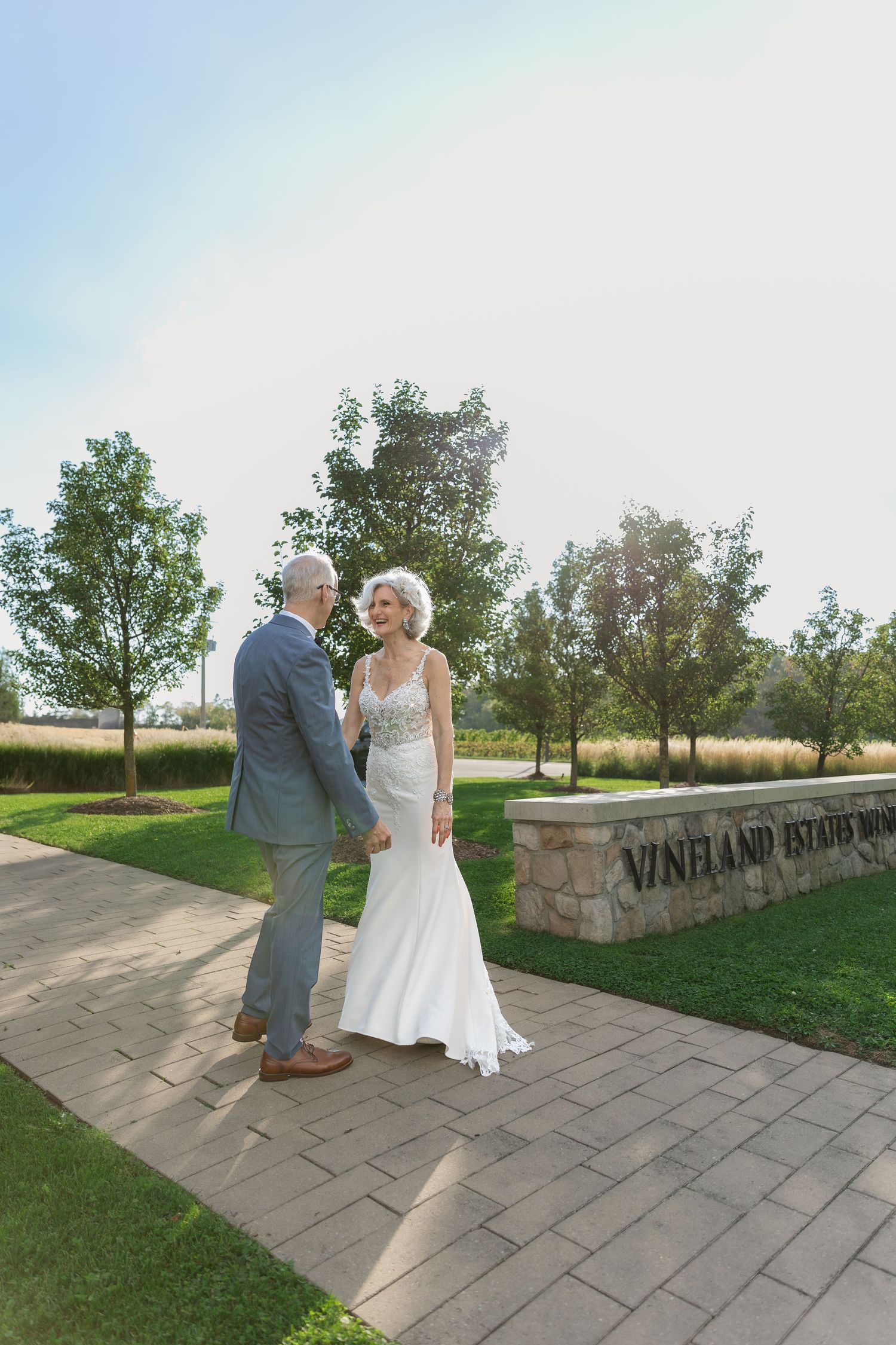 Stone pathway with Vineland Estates signage creates perfect backdrop for wedding photos.