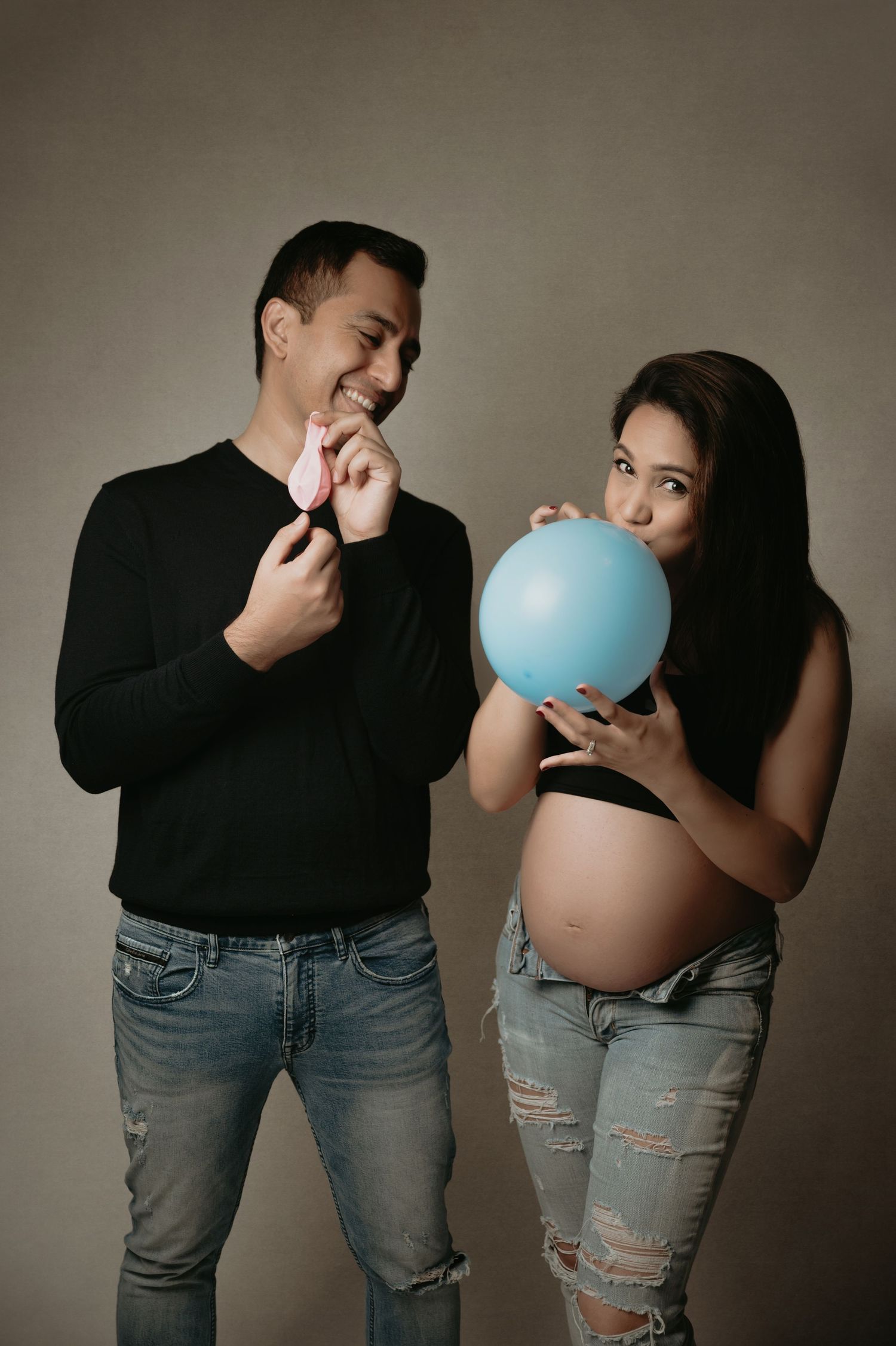 A creative pregnancy photo series showing a couple blowing up and passing a blue balloon to reveal a gender announcement.