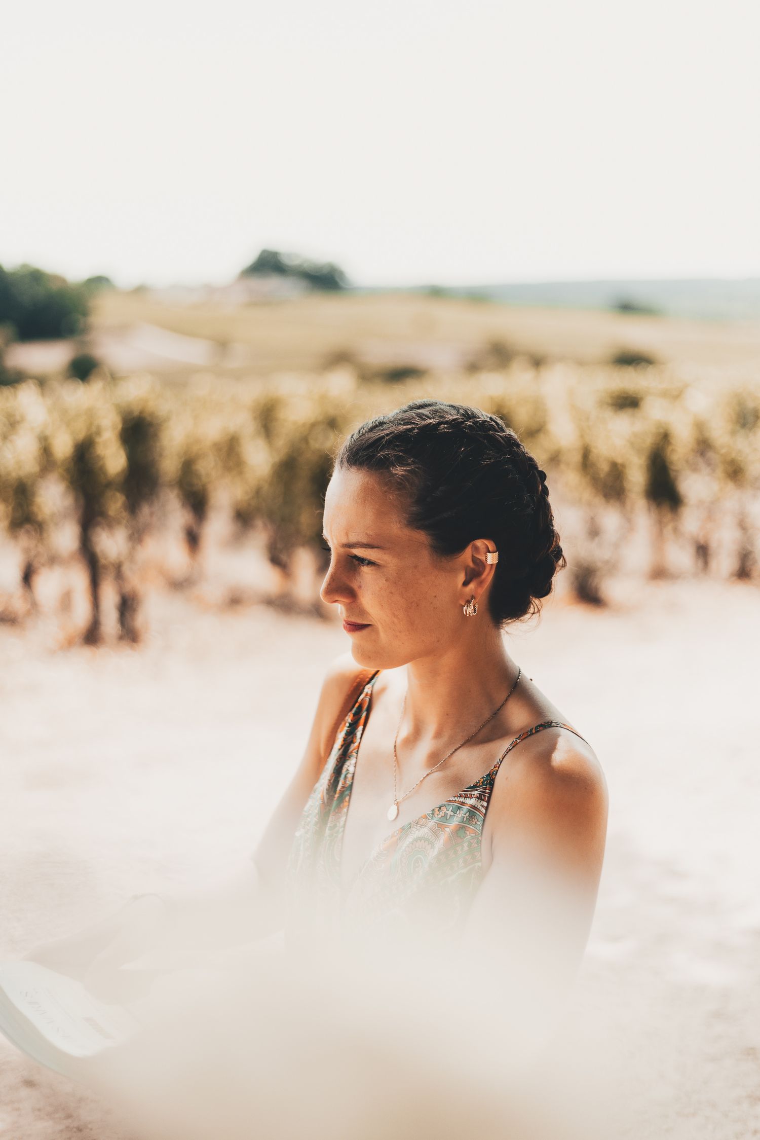 Artistic profile portrait series of a woman in a dreamy wheat field with soft focus and natural lighting.