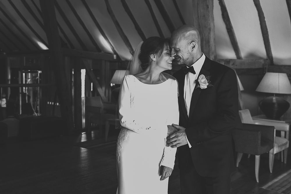 Black and white wedding photo capturing movement and celebration on the dance floor.