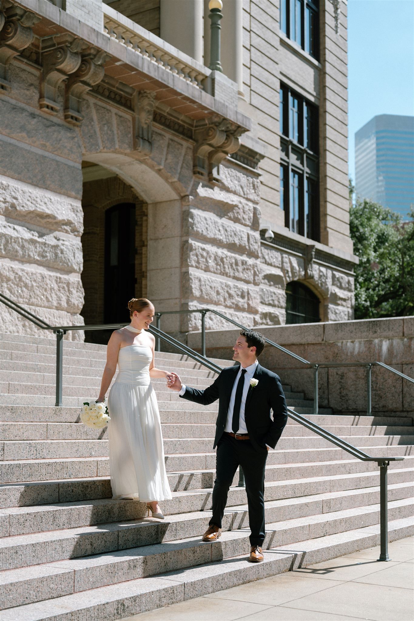 A couple in formal attire walking up stone steps of a historic building entrance in a sequence of four photos.