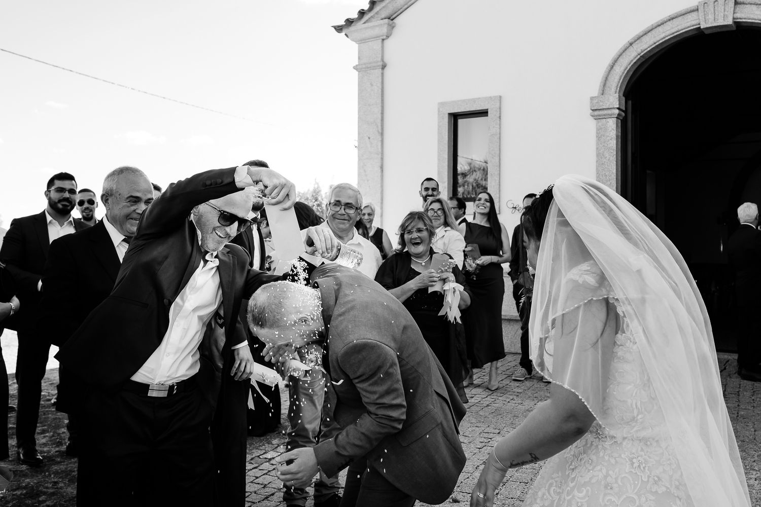 A romantic wedding kiss captured in soft lighting during an intimate ceremony.