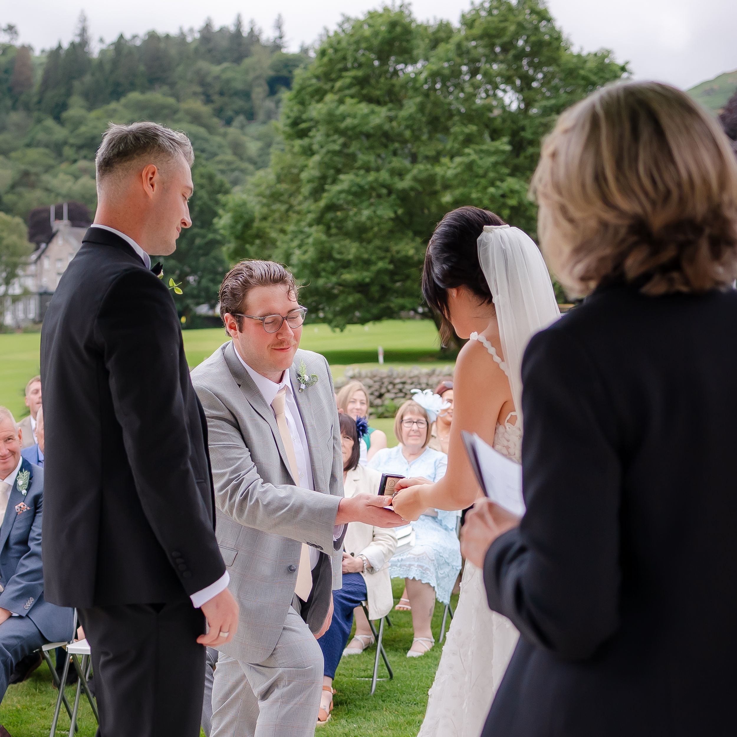 wedding photography in Cumbria - best man handing the ring over