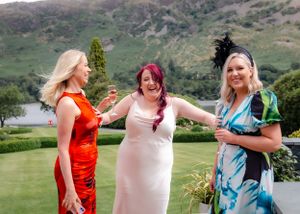 wedding photography in Cumbria - bridesmaid laughing with guest