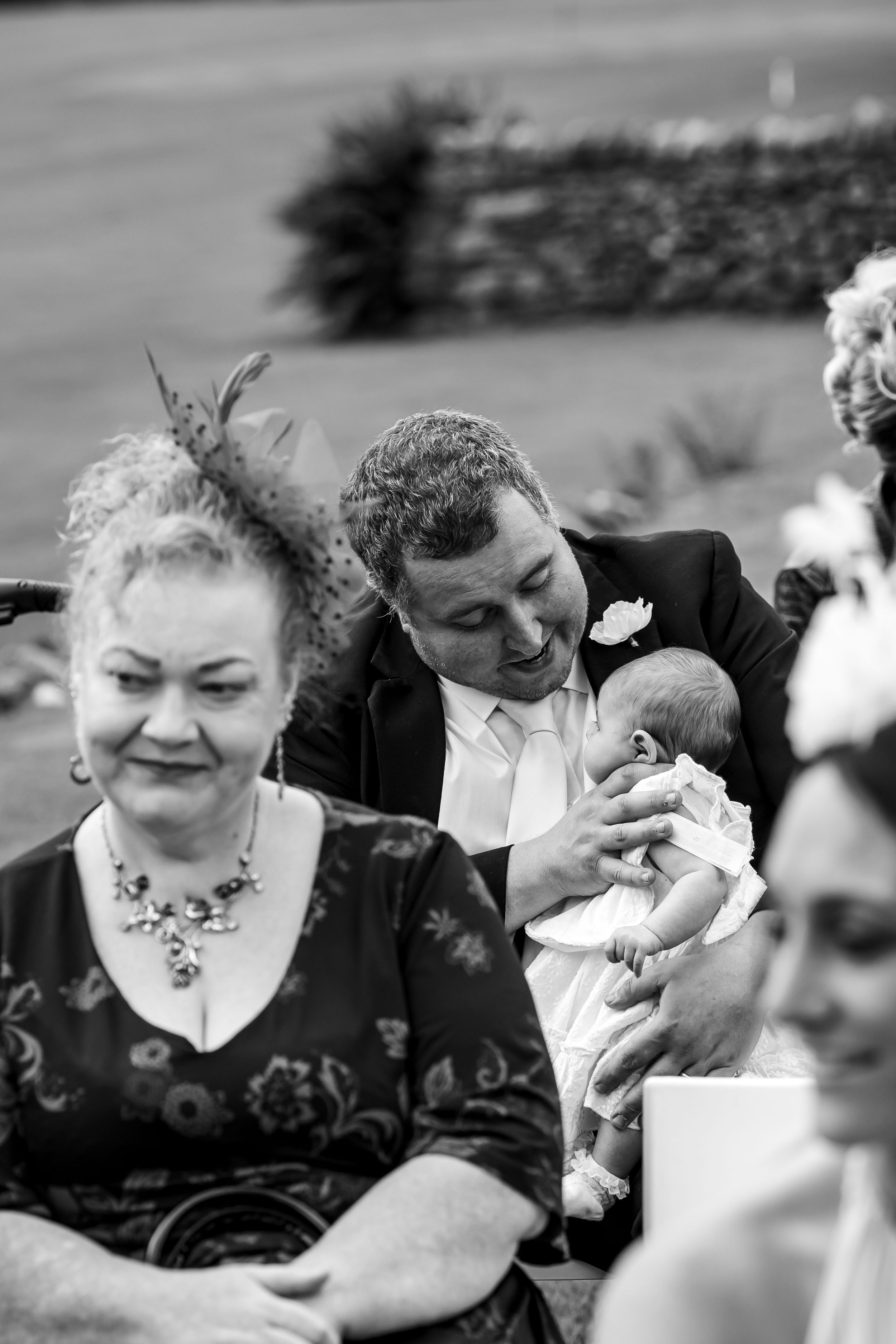 wedding photography in Cumbria - baby having her feed during the ceremony