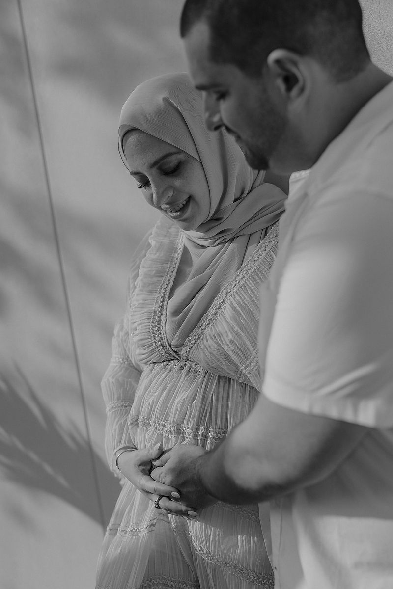 Couple embracing during pregnancy session in the Caribbean.