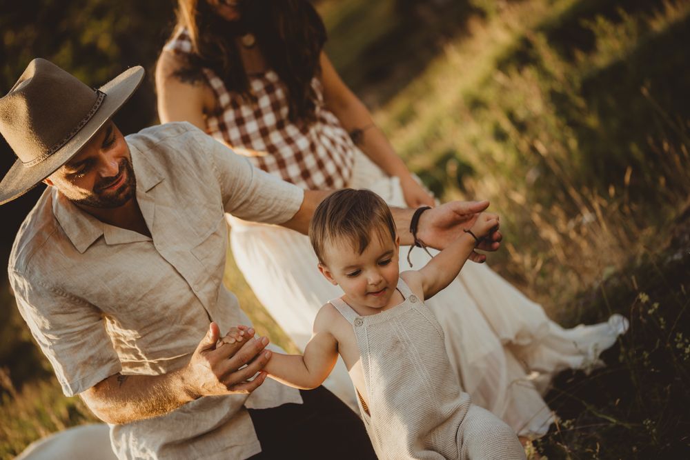 Family having fun together outdoors during golden hour in a rustic country setting.