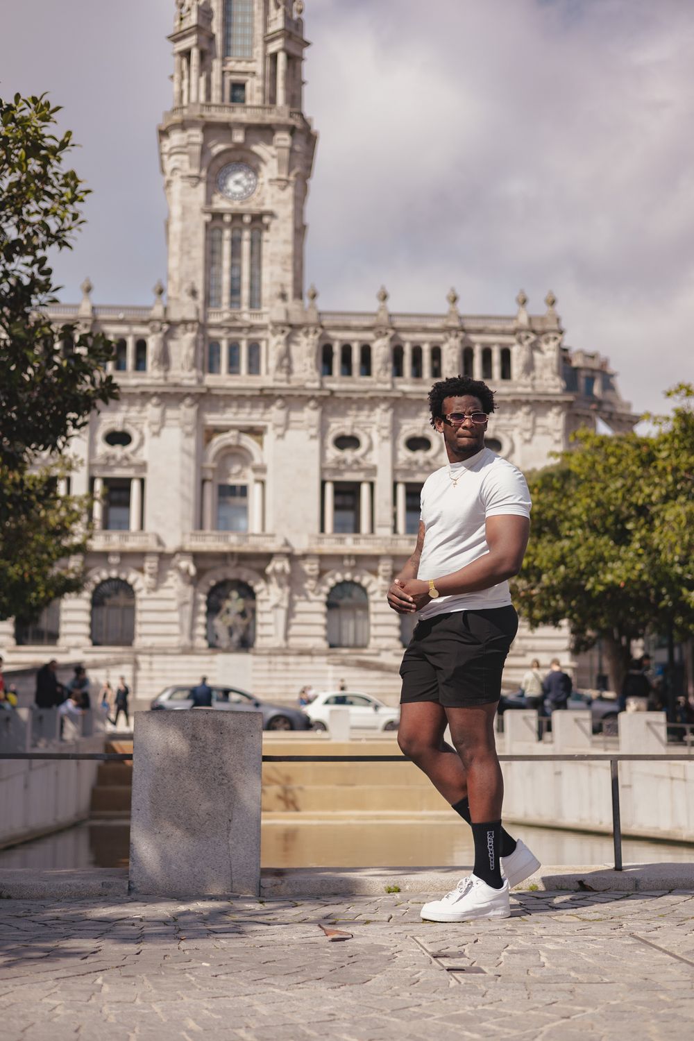 Outdoor portrait session in front of ornate historic European architecture.