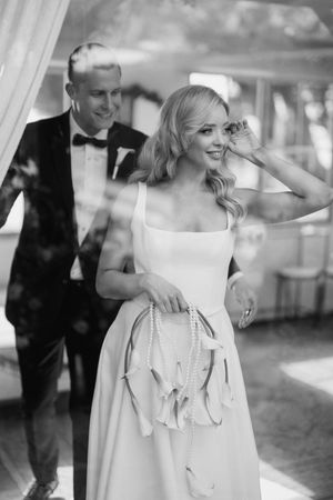 A series of black and white wedding photos showing a couple dancing and celebrating at their elegant reception.