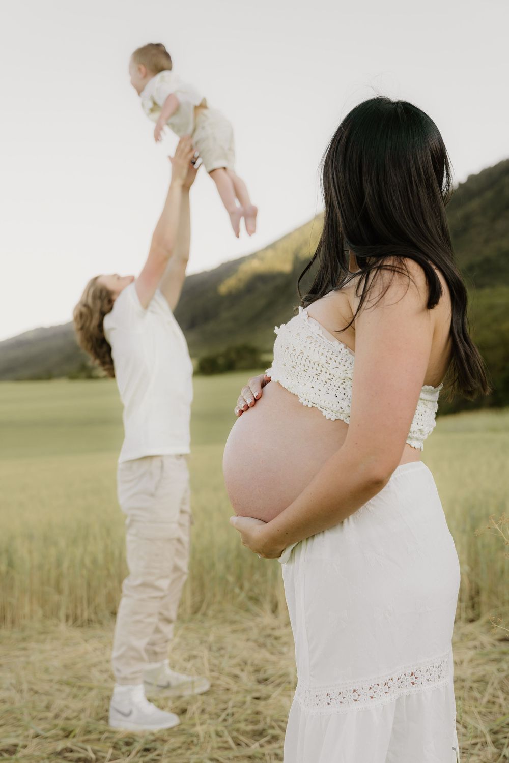 Happy family moments captured in a wheat field on a sunny afternoon.