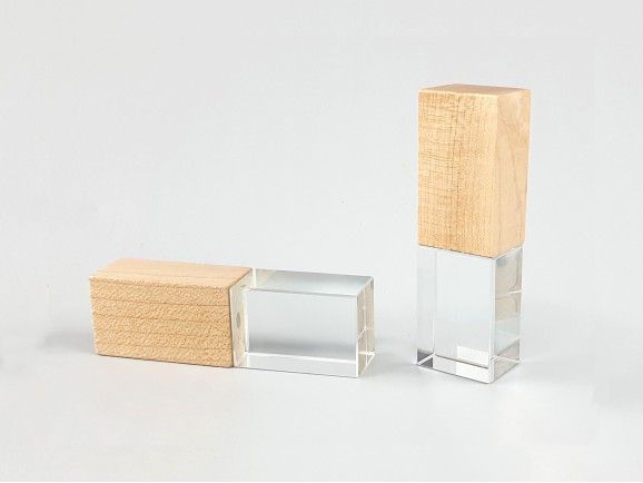 Two wooden and crystal USB flash drives with transparent glass sections displayed on a white background.