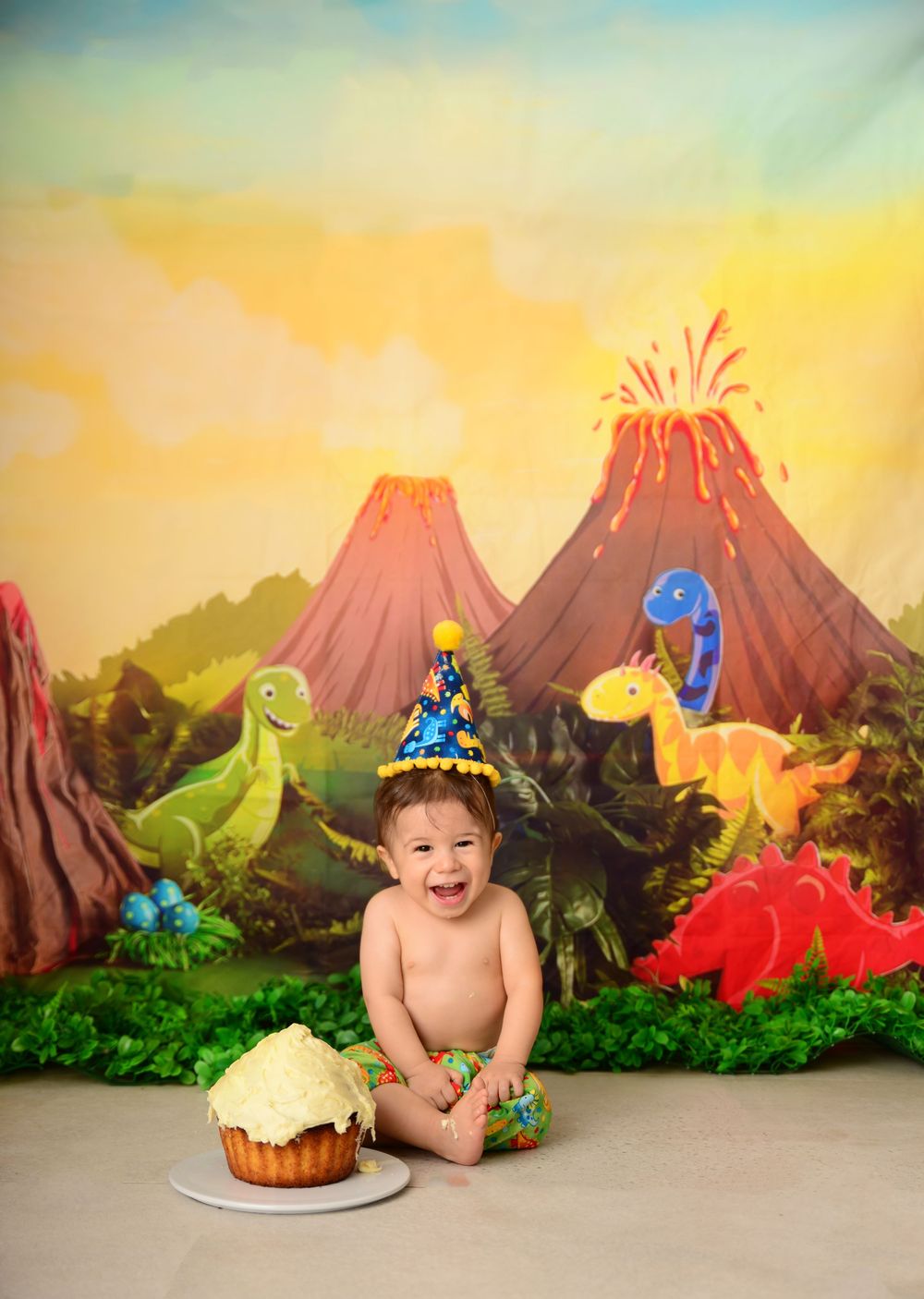 first birthday cake smash, dinosaur themed backdrop. portraits in Campbelltown by Cotton Cloud Photography