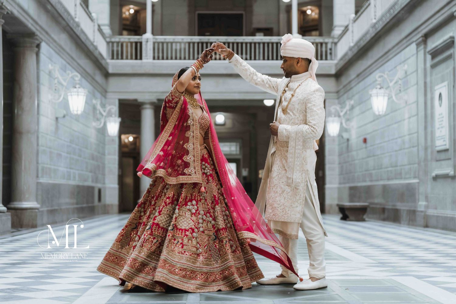 Groom twirls bride in her elegant lehenga, all smiles and laughter in a candid moment from Puja & Kushal's wedding, exuding joy and love