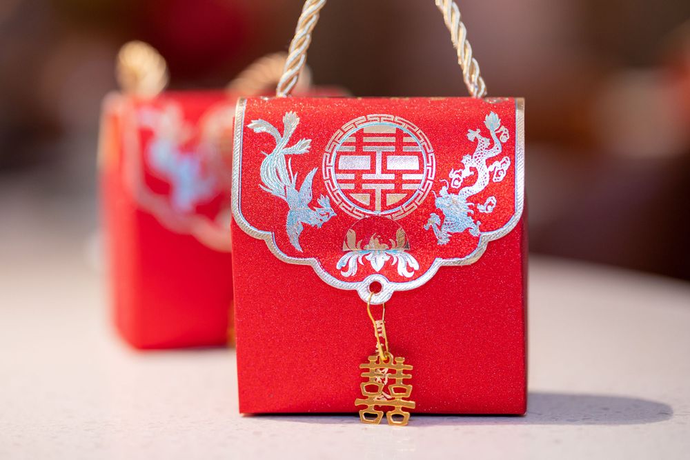 Traditional red Chinese wedding favor boxes with double happiness symbol.
