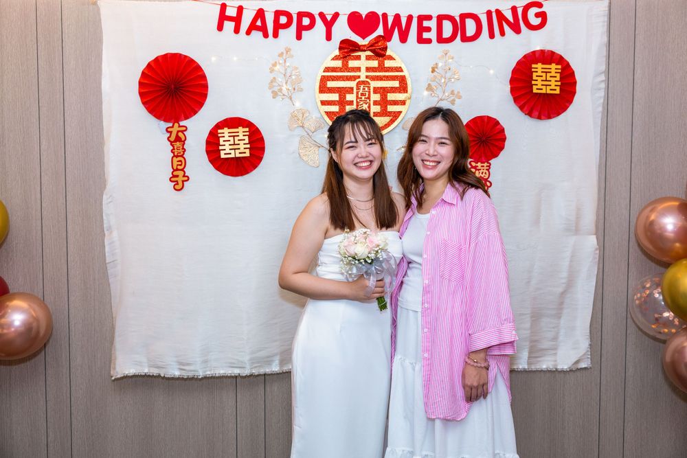 Wedding celebration with traditional Chinese decorations and happy celebrants.