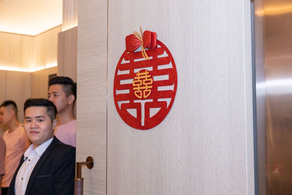 Traditional Chinese double happiness symbol in red displayed on a wall.