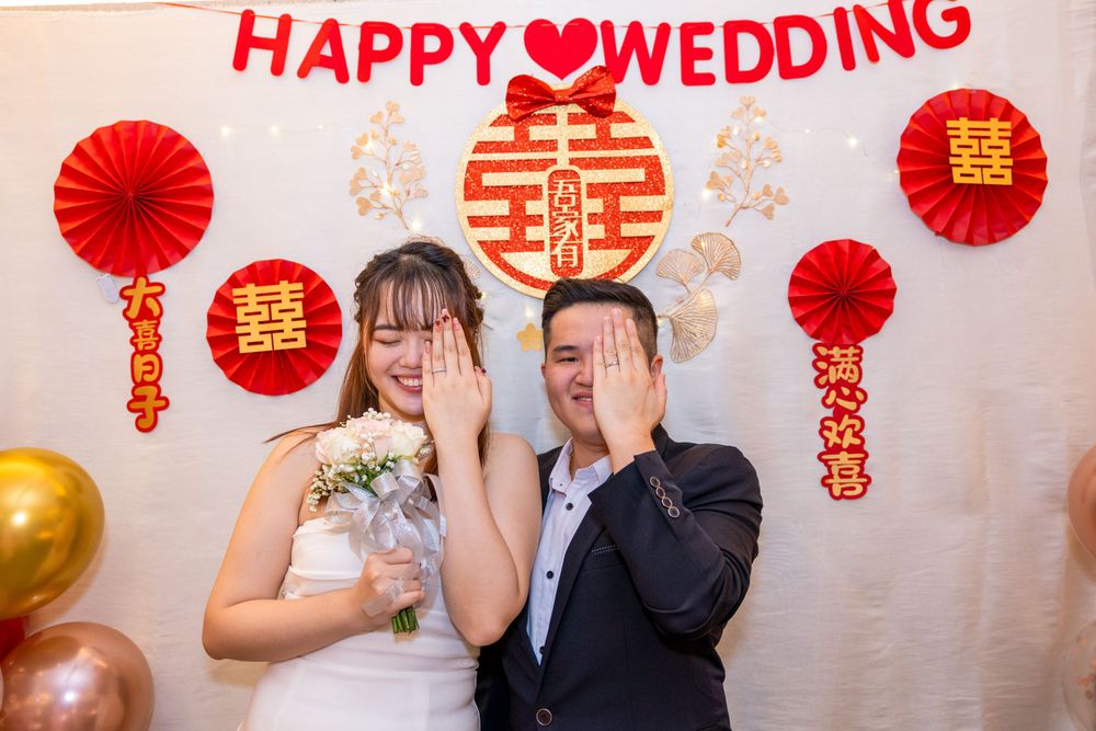 Traditional Chinese wedding celebration with red and gold decorations and double happiness symbol.