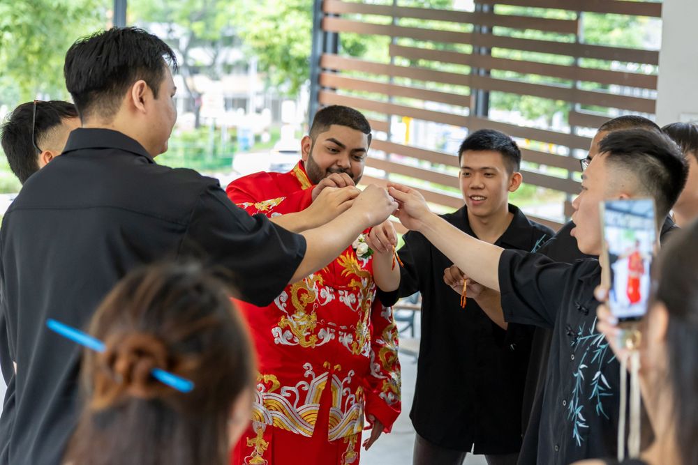 Group of people engaging in traditional wedding games and celebrations.