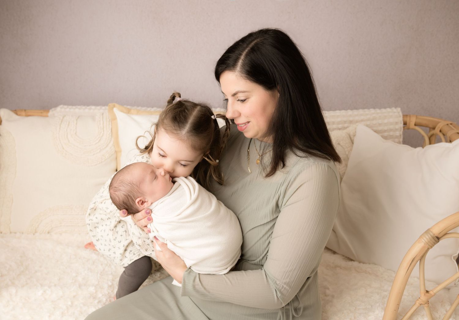 A series of tender moments between parent and child lying together on a cozy white bed.