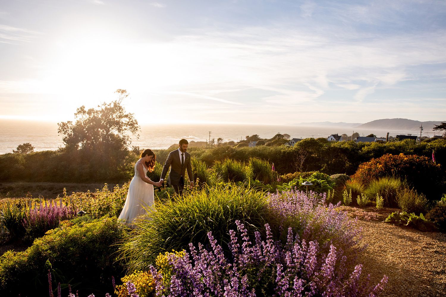 Wedding couple walking portraits at Switzer Farm, Mendocino, CA with the ocean view
