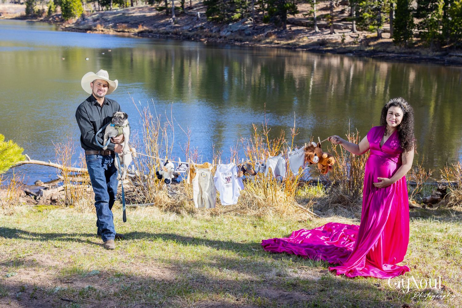 People enjoying a relaxing afternoon by the lake with a bright pink dress adding a pop of color to the natural scenery.