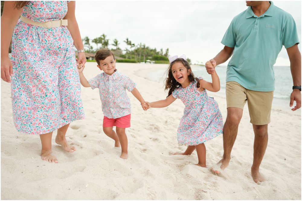 Four Seasons Punta Mita family photography session, family walking together on a sunny white sand beach.