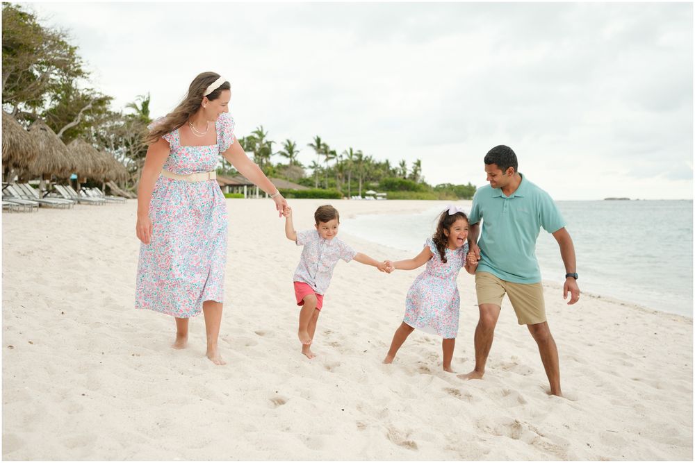 Four Seasons Punta Mita family photography session, family walking and playing along a tropical beach shoreline.