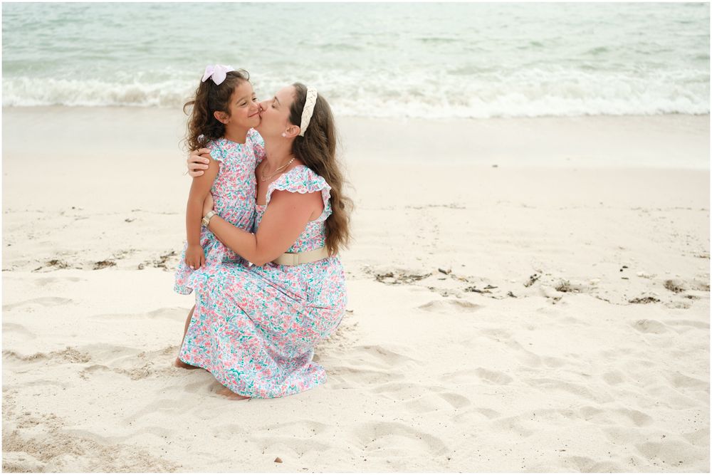 Four Seasons Punta Mita family photography session, beach portraits with matching floral dresses and turquoise ocean backdrop.