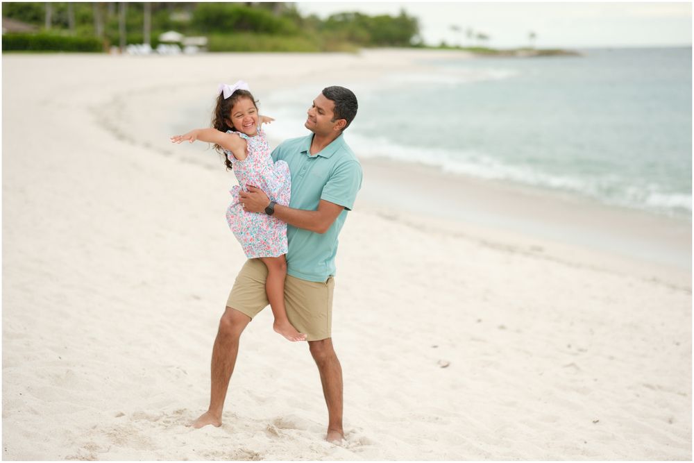 Four Seasons Punta Mita family photography session, couple embracing on a serene white sandy beach.