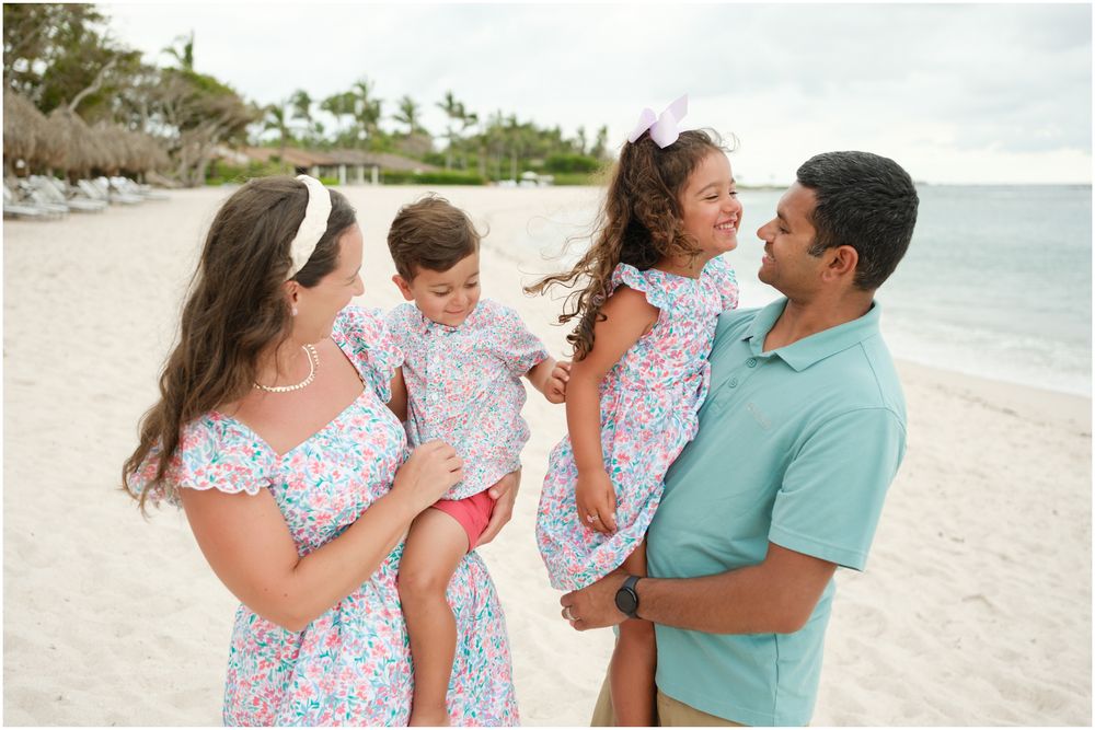 Four Seasons Punta Mita family photography session, family enjoying a playful moment on a white sandy beach with ocean views.